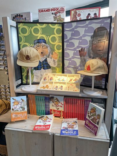 Wombles merchandise in the gift shop: pin badges, caps and books