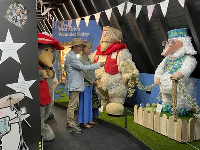 Marcus and Marianne look at the Womble sculptures Marcus pointing at the Womble sculptures while Marianne laughs and Orinoco is watching