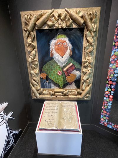 Portrait of Great Uncle Bulgaria in a golden frame made of bottles and tins