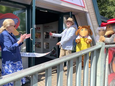 Marcus Robertson cuts the ribbon Marcus Robertson cuts the ribbon, wtih Vanessa Pugh and the Wombles clapping