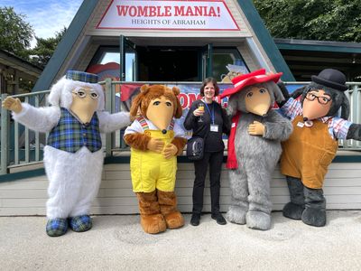 Tara meets the Wombles Tara holding a glass of Buck's Fizz with Great Uncle Bulgaria, Alderney, Orinoco and Tobermory outside the exhibition